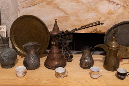 Safranbolu, Karabuk, Turkey - December 29 2022: Ottoman period copper coffee pot and cups.