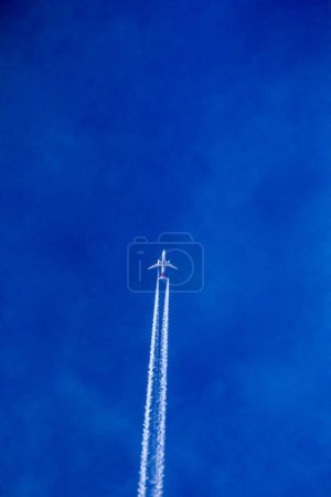 Photo for Airplane high in the blue sky - Royalty Free Image