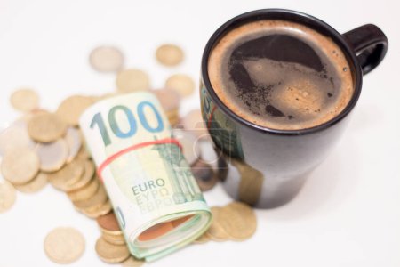 Photo for Cup with coffee near banknotes and coins. Rising prices due to the war in Ukraine - Royalty Free Image