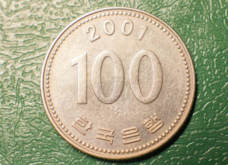 Photo for Obverse of the coin 100 Korean won on a dark background. - Royalty Free Image