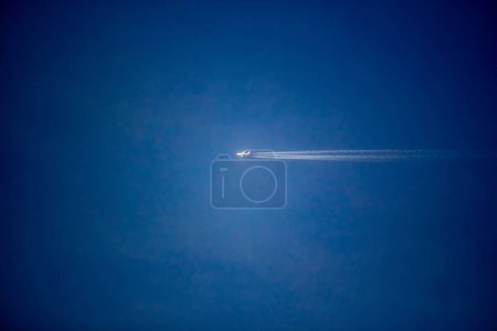Photo for Airplane flying high in the blue sky - Royalty Free Image