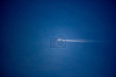 Photo for Airplane flying high in the blue sky - Royalty Free Image