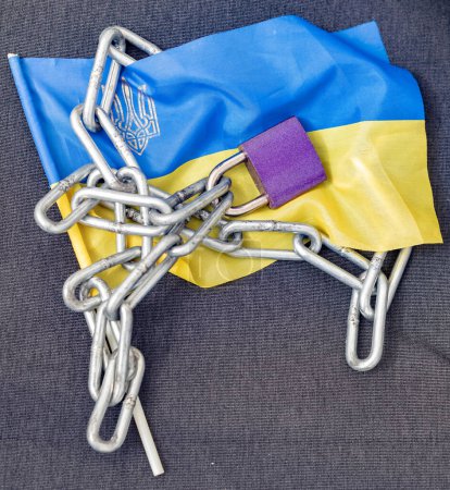 Chain lock on Ukraine flag. Ban on citizens leaving the country