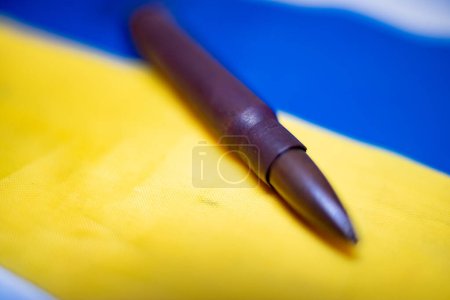 Bullet on the Ukrainian flag. Endless war in Ukraine with many casualties