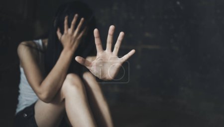 Photo for Scared young woman sitting in the corner of her bedroom, despair rape victim waiting for help,The concept of stopping violence against women and rape. - Royalty Free Image