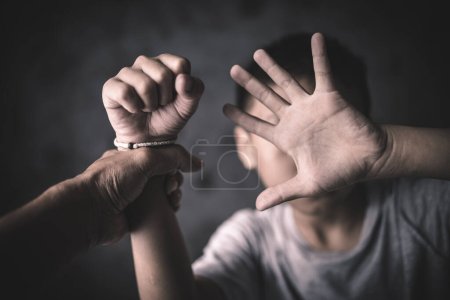 Photo for Children who are victims of human trafficking Tied the rope attached to the wrist with stress and emotional pain.Hands of a missing kidnapped, abused, hostage,   afraid, restricted, trapped, - Royalty Free Image