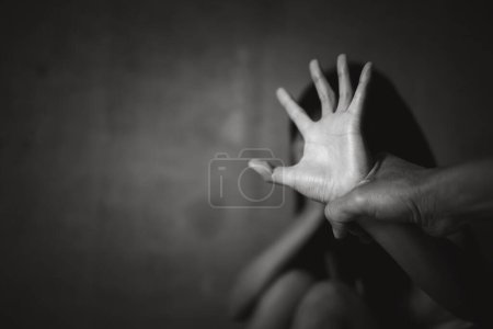 Photo for Young depressed woman, domestic and rape violence,beaten and raped sitting in the corner, Domestic violence. Copy space. - Royalty Free Image