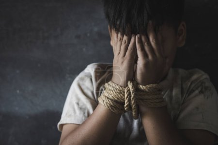 Photo for Children who are victims of human trafficking Tied the rope attached to the wrist with stress and emotional pain.Hands of a missing kidnapped, abused, hostage,   afraid, restricted, trapped, - Royalty Free Image