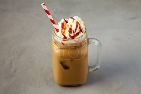 Photo for Homemade Caramel Iced Latte with Whipped Cream in a Glass Jar, side view. - Royalty Free Image