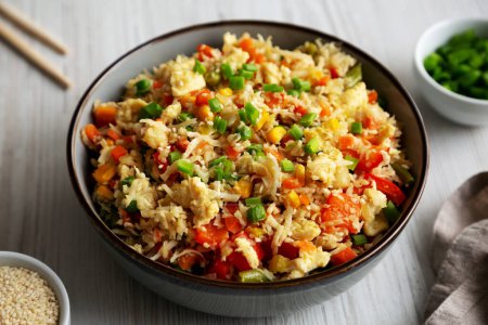 Photo for Homemade Cauliflower Fried Rice with Chives and Sesame Seeds in a Bowl, side view. Close-up. - Royalty Free Image