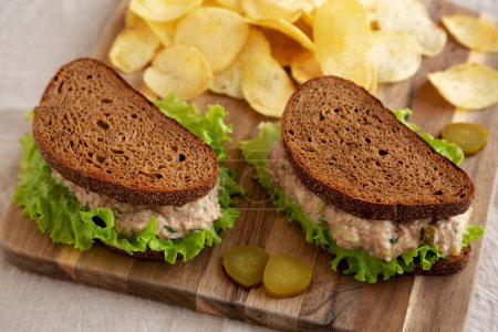 Photo for Homemade Tuna Sandwich with Lettuce on a wooden board, side view. - Royalty Free Image