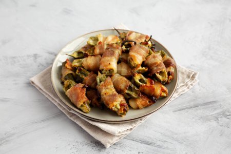Photo for Homemade Bacon-Wrapped Jalapeno Poppers on a Plate, side view. - Royalty Free Image