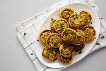 Homemade Chicken Pesto Pinwheels on a Plate, top view. Flat lay, overhead, from above. Copy space.