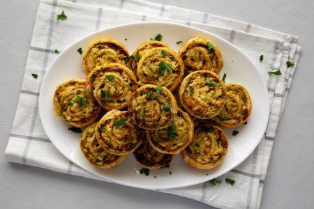 Homemade Chicken Pesto Pinwheels on a Plate, top view. Flat lay, overhead, from above. 