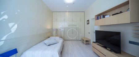 Photo for Modern scandic interior in light beige tones of bedroom in luxury apartment. Cozy bed. Huge wardrobe. - Royalty Free Image