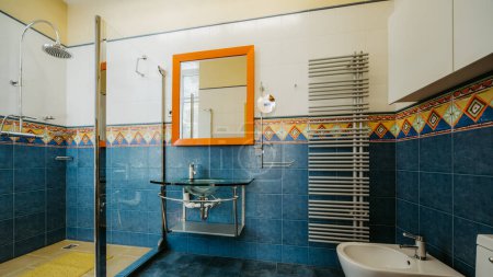 Photo for Modern interior of bathroom in luxury apartment. Blue and yellow. Glass shower cabin. - Royalty Free Image