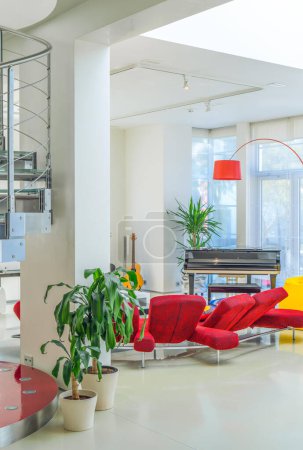 Photo for Modern interior of luxury private house. Spacious living room. White walls. Red sofa. - Royalty Free Image