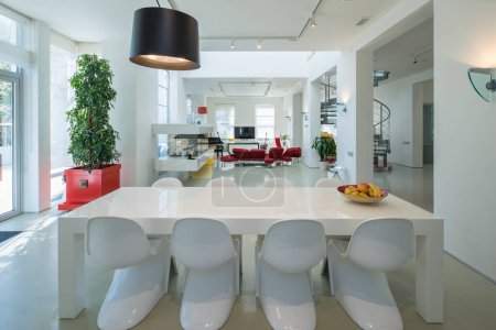Photo for Modern interior of luxury private house. Spacious living room with dinner table and chairs. White walls. - Royalty Free Image
