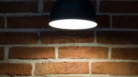Photo for Close-up of a lamp near a brick wall. Illumination. - Royalty Free Image