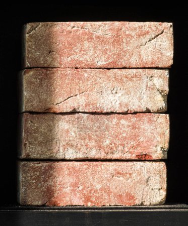 Close-up of a stack of four bricks. Material for construction.