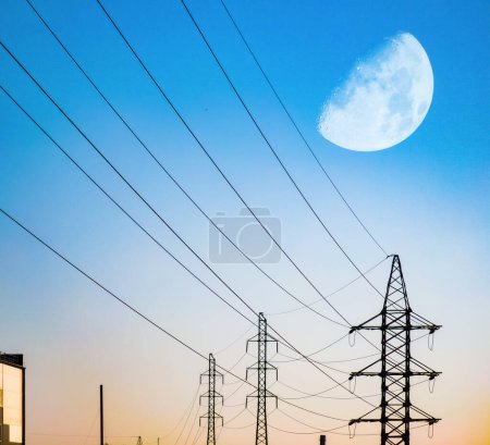 Photo for High voltage electricity power line towers. Huge moon in sky. - Royalty Free Image