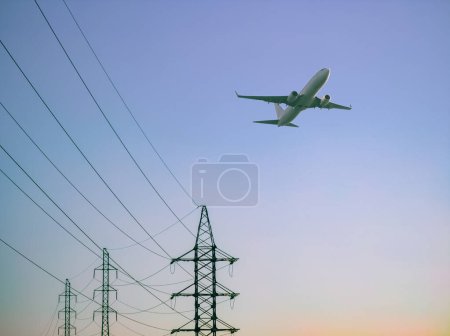 Photo for High voltage electricity power line towers against the sky. Airplane. - Royalty Free Image