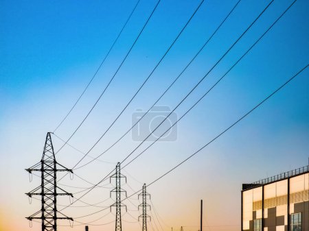 Photo for High voltage electricity power line towers against the sky - Royalty Free Image