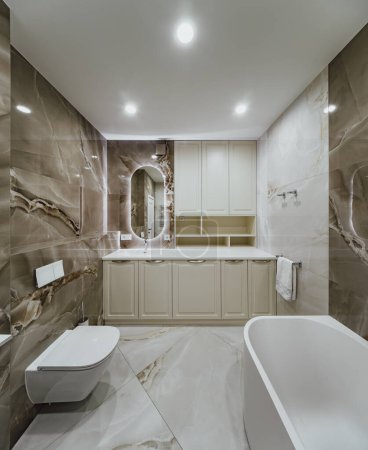 Photo for Bright modern bathroom with stone tiles on the walls. - Royalty Free Image