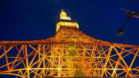 Photo for TOKYO, JAPAN  APRIL 2024 Spectacular perspective view of Tokyo Tower illuminated at night. The Tokyo Tower is a telecommunications building and also a panoramic observatory located in Minato district, Tokyo, Japan. - Royalty Free Image