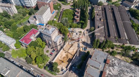 Photo for Drone aerial view to the land plot on which the construction process is taking place on a sunny summer day. Building former factory Arsenal. Kyiv Kiev capital of Ukraine - Royalty Free Image