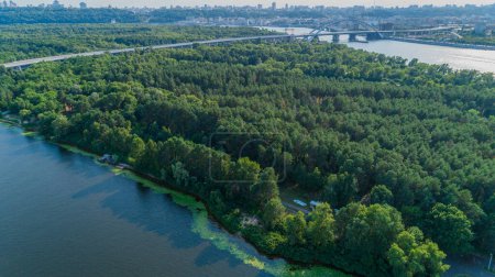 Foto de Aerial view summer forest and river in sunny day. Drone shot beautiful nature landscape, green trees - Imagen libre de derechos