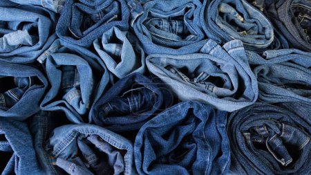 Photo for Roll folded blue cotton denim jeans. High quality photo - Royalty Free Image