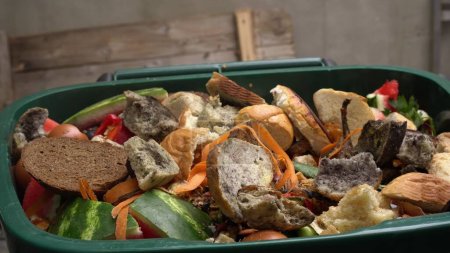 A dumpster with food leftovers. Food waste in foodservice industry. Global food crisis. High quality photo