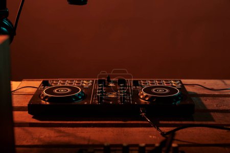Empty table with stereo turntables and dj equipment, audio instrument with microphone and headphones. Electric vinyl used at nightclub or party to mix and listen to techno music, electronics.