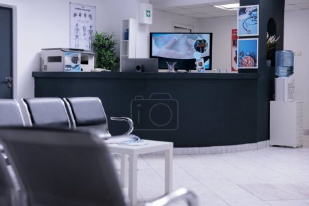 Photo for Nobody in hospital reception desk and waiting room at facility to attend medical consultation appointment. Waiting area lobby with chairs and counter at healthcare clinic, disease medicine. - Royalty Free Image