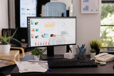 Photo for Close up view of monitor with sales growth graphs on screen previous to brainstorming meeting. Placed on desk statistical reports printed on handouts and work materials. - Royalty Free Image