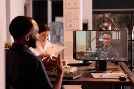 Foto de African american company ceo speaking on videoconference with coworker, business strategy discussion on videocall. Teamleader talking on teleconference, corporate online meeting - Imagen libre de derechos