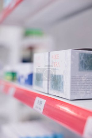 Foto de Drugstore shelves stocked with various medicinal products and aloe vera cream ready for clients to come and buy during checkup visit in pharmacy. Medicine support service and concept - Imagen libre de derechos