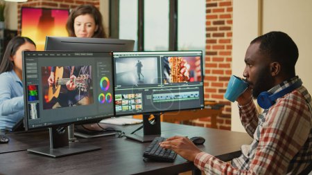 Téléchargez les photos : Digital footage editor working on video production at multi monitor workstation, creating professional content. Video editing artist using cinematography software to edit film or movie montage. - en image libre de droit