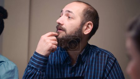 Photo for Man talking in business meeting close view, slow motion, employee discussing company strategy, brainstorming. Office worker speaking, sitting at boardroom table at night time. Handheld shot. - Royalty Free Image