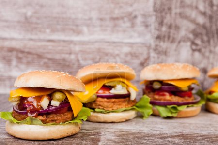 Téléchargez les photos : Burgers on wooden plate. Fast food. Unhealthy snack - en image libre de droit