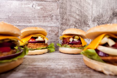 Photo for Close up of Delicious home made burgers on wooden plate. Fast food. Unhealthy snack - Royalty Free Image
