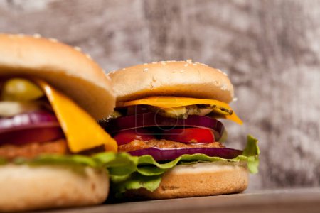 Photo for Delicious home made snack burgers on wooden plate. Fast food. Unhealthy snack - Royalty Free Image