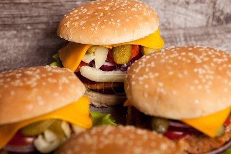 Téléchargez les photos : Delicious home made snack burgers on wooden plate. Fast food. Unhealthy snack - en image libre de droit