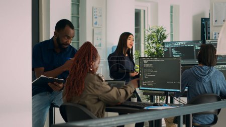 Photo for African american team of cloud programers talking about programming compiling code, working on new user interface development. Coders doing teamwork to develop server algorithms. - Royalty Free Image