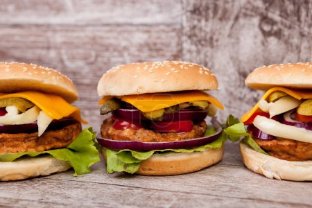 Photo for Gourmet burgers on wooden plate. Fast food. Unhealthy snack - Royalty Free Image