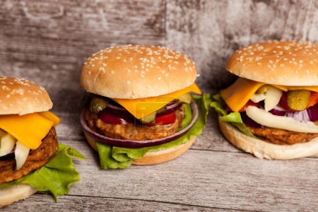 Téléchargez les photos : Home made burgers on wooden plate. Fast food. Unhealthy snack - en image libre de droit
