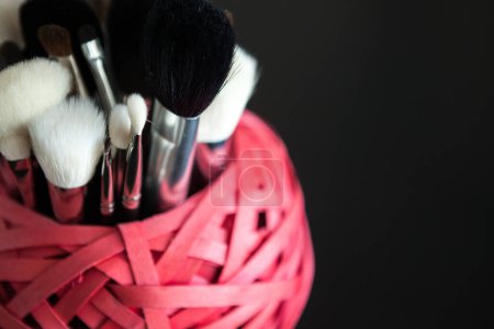 Téléchargez les photos : Make up and cosmetics products on black background. Professional Cosmetics - en image libre de droit