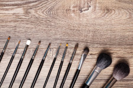 Photo for Professional make-up brushes on wooden background. Beauty industry - Royalty Free Image