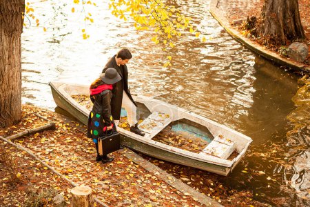 Photo for Couple next to a boat in park. Romance and love - Royalty Free Image